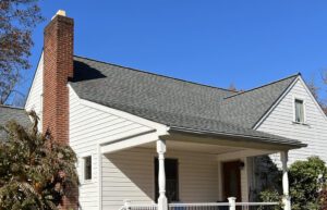 White house with brick chimney and gable roof