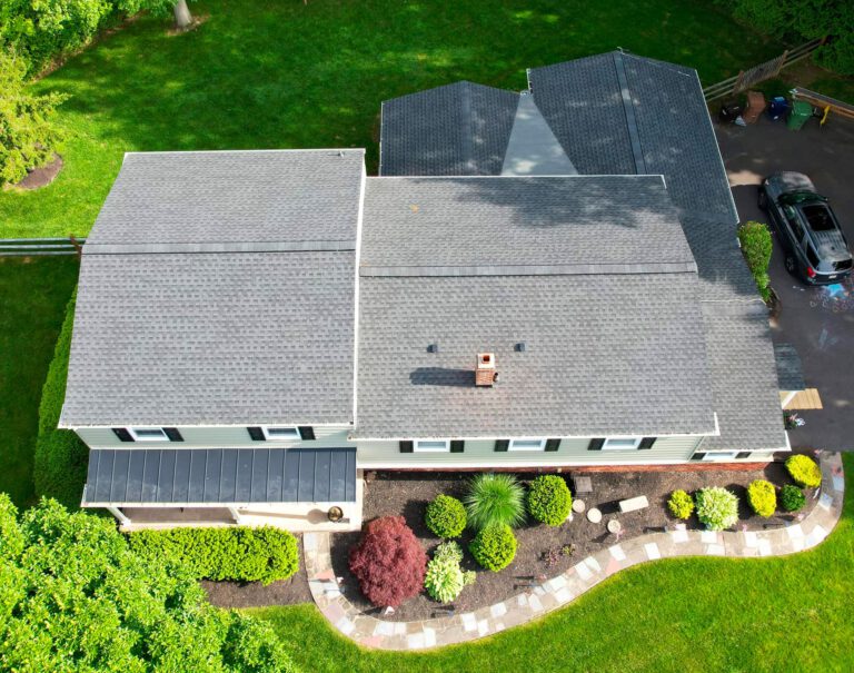 Aerial view of house with gray roof and garden