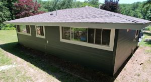 Gray house exterior with windows and roof