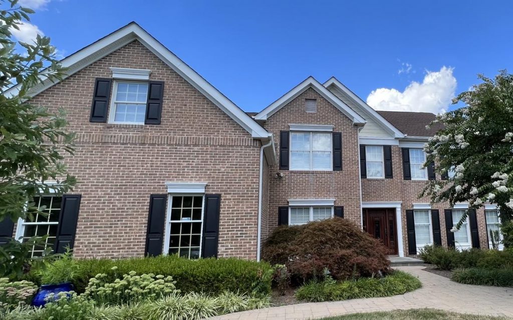 Brick house with blue sky background.