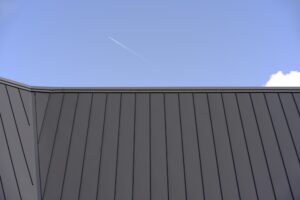 Gray metal roof against clear blue sky