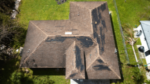 Aerial view of house roof with missing shingles.