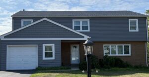 Front view of blue-gray home after siding remodel