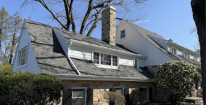 A charming stone and wood house with a sloping roof.
