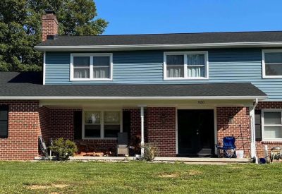Exterior view of a renovated house with new roofing and siding in Bethlehem PA.