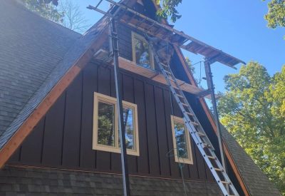 High-quality window and siding installation on a residential home. Skilled construction team upgradi.