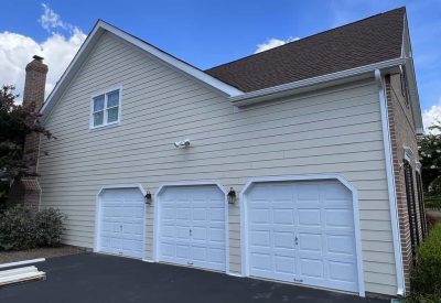 Custom siding replacement and new garage doors in Doylestown PA by Kesting Construction.