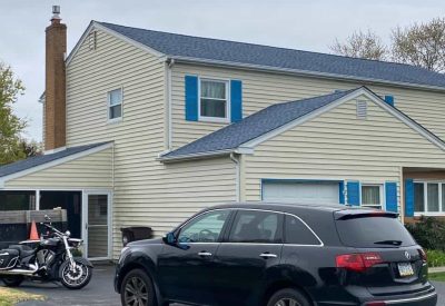 Siding installation on a two-story house in Trooper PA by Kesting Construction.
