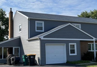Left side view of blue-gray home after siding remodel
